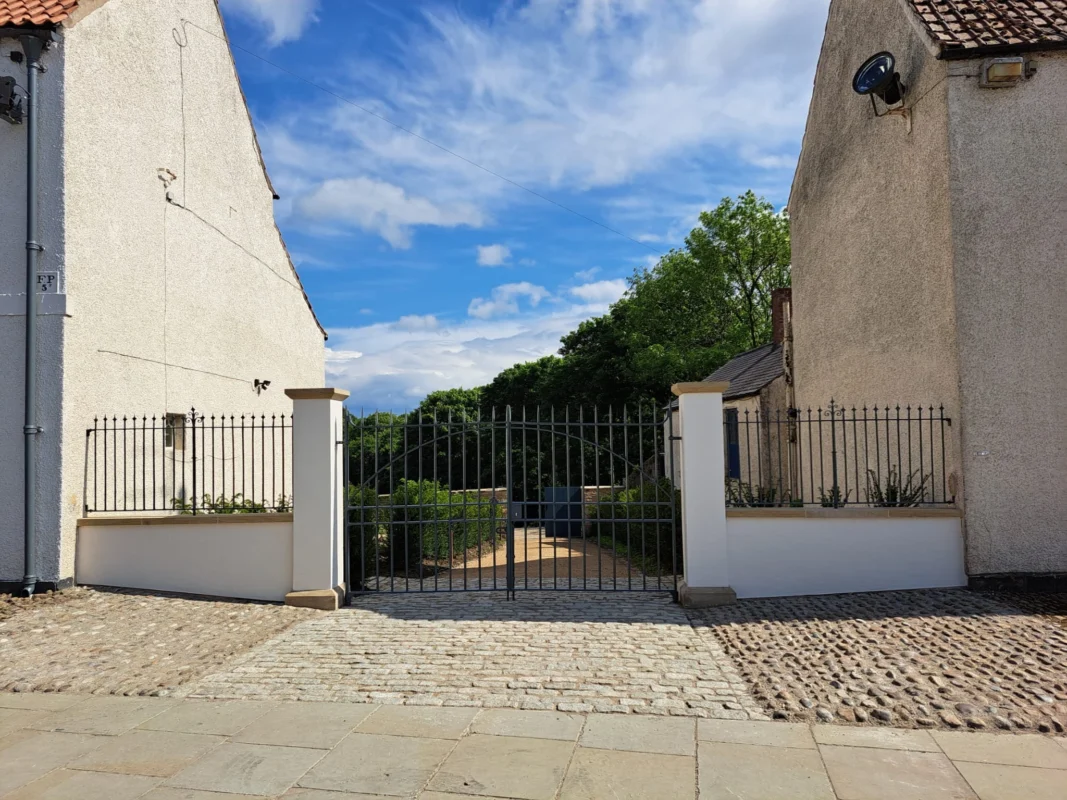 A steel gate leading to Auckland Gardens.