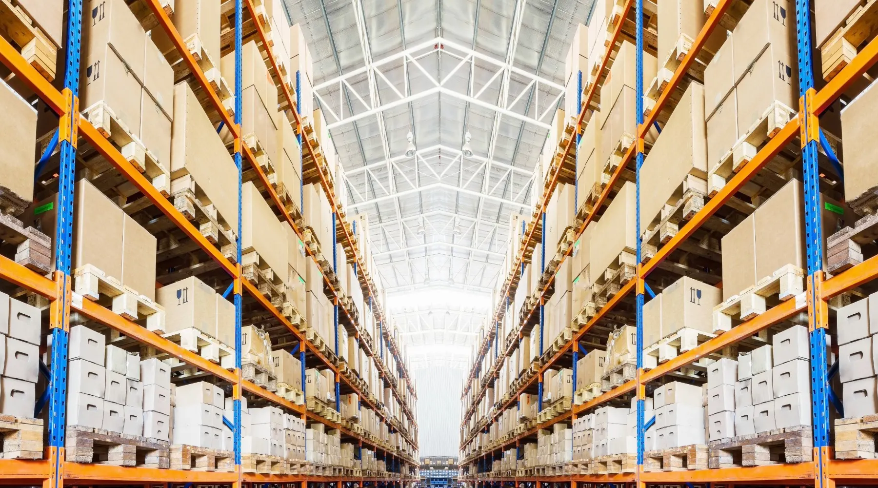 A large, modern warehouse with orange and blue shelving.