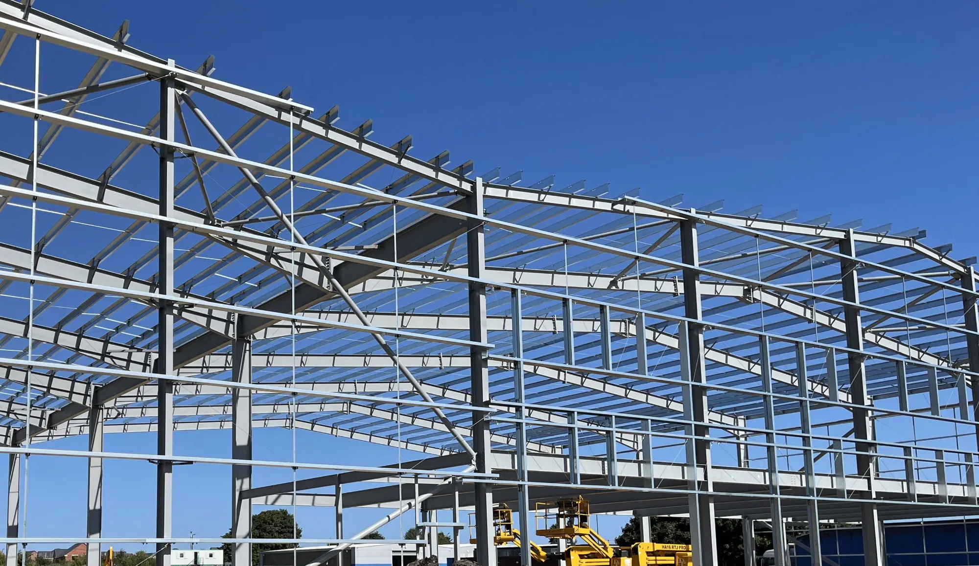 A large steel frame in front of a clear blue sky.